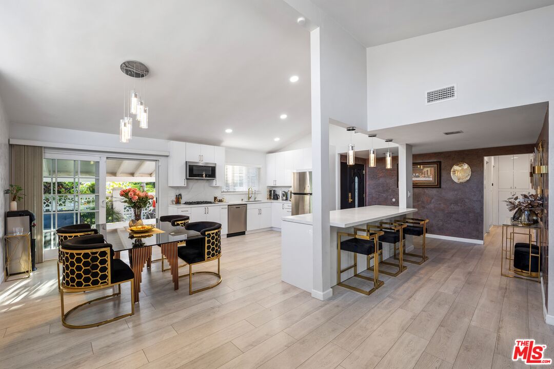 a living room kitchen with furniture and kitchen view