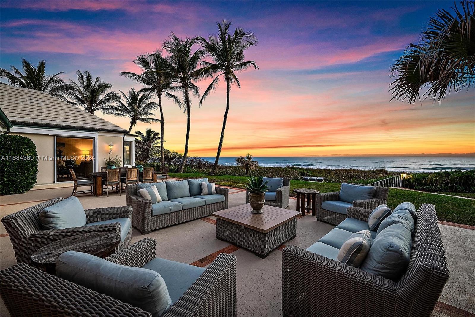 a view of a patio with couches and a fire pit