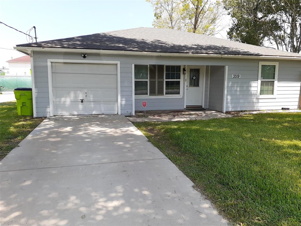 a front view of a house with a garden and yard