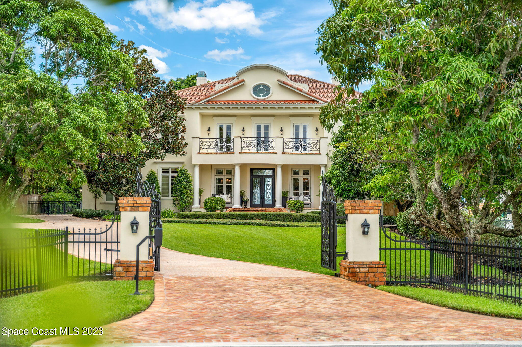 a front view of a house with a garden and yard