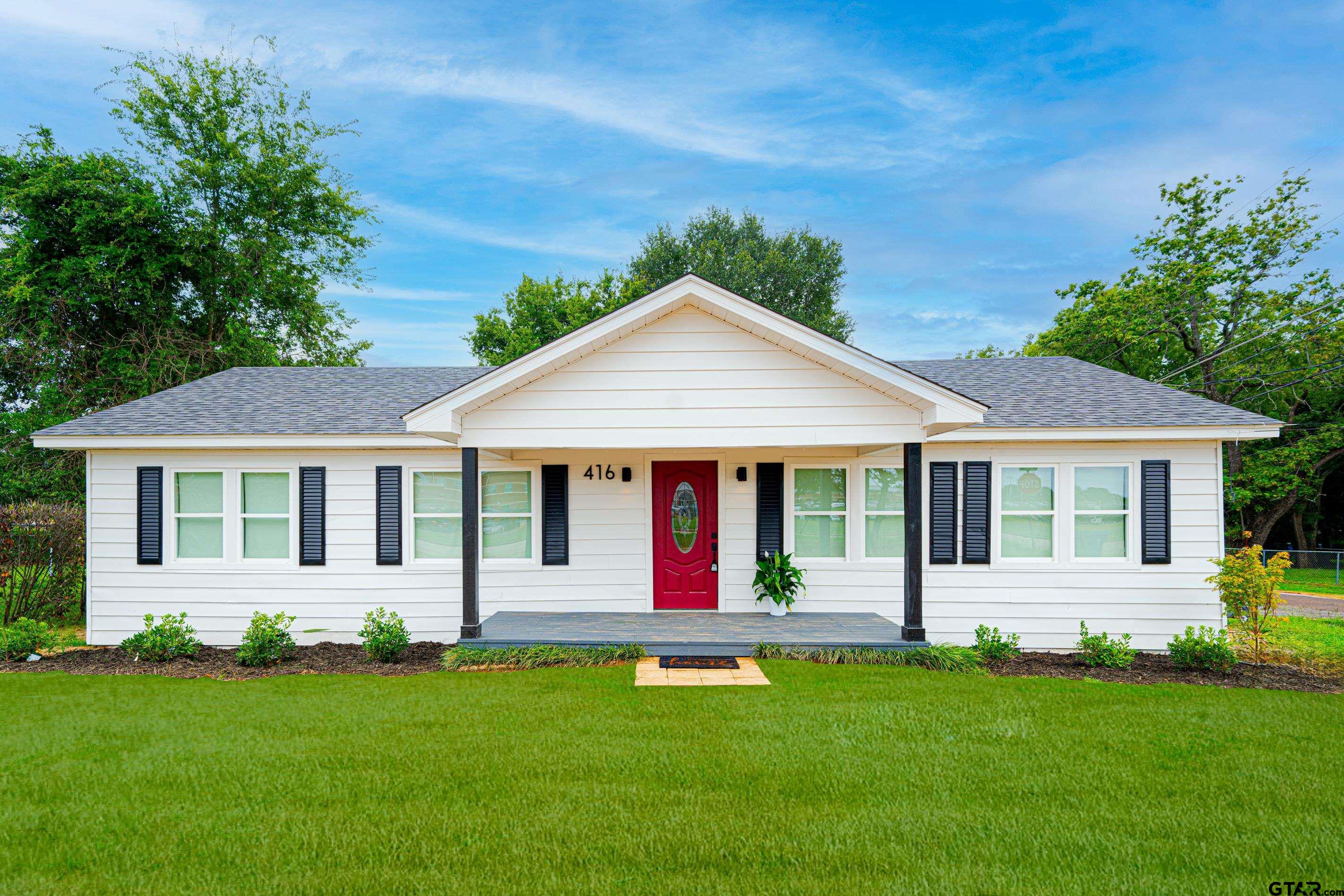 front view of a house with a yard