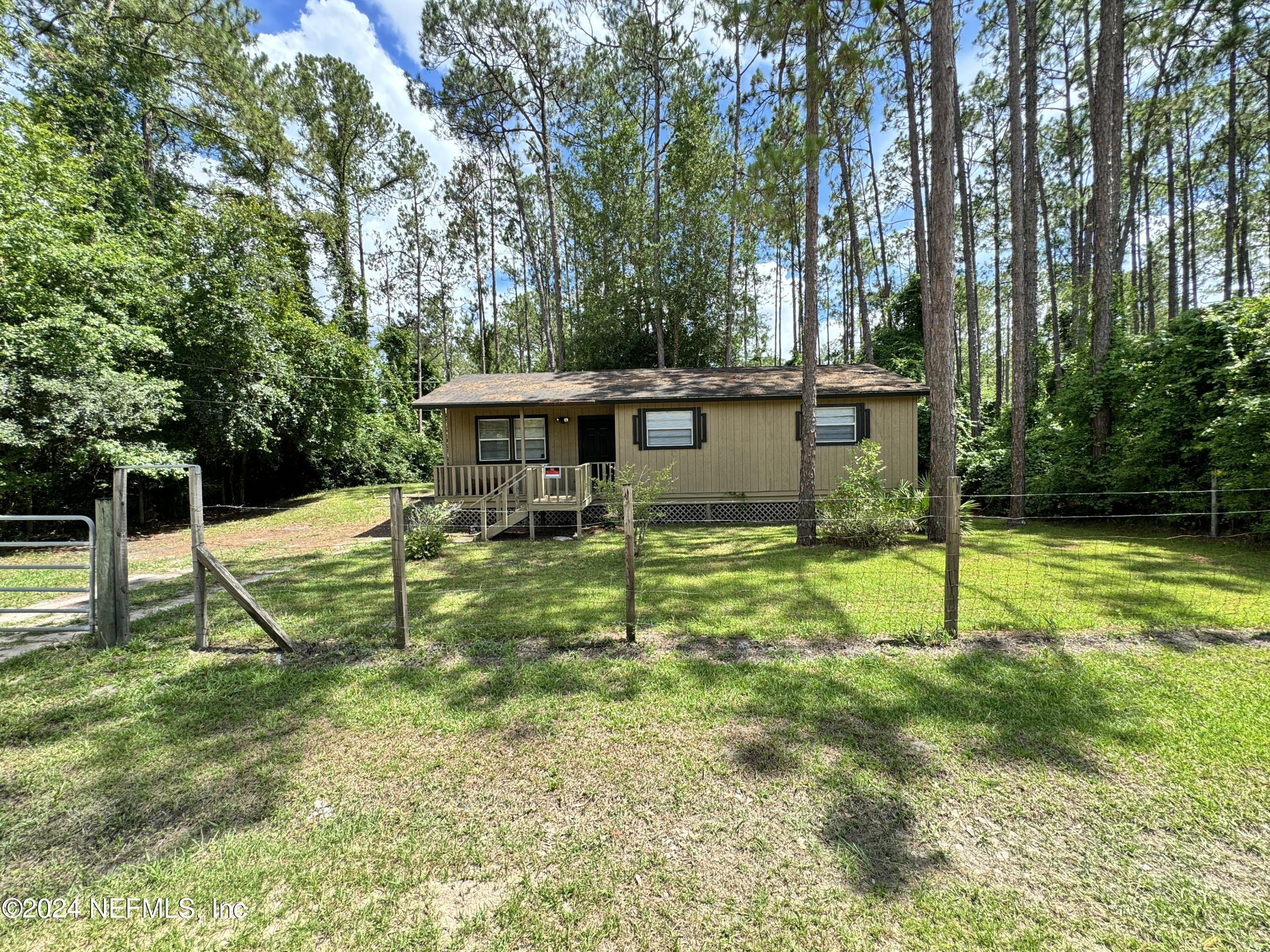 a view of a house with backyard and a slide