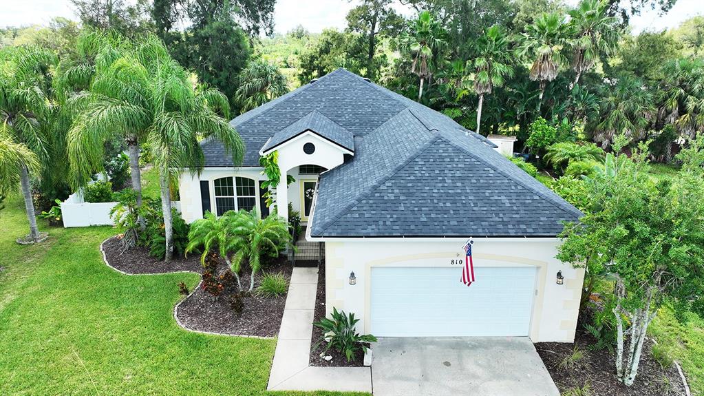 a aerial view of a house with a yard and potted plants