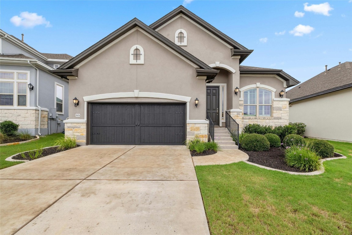 a front view of a house with a yard and garage