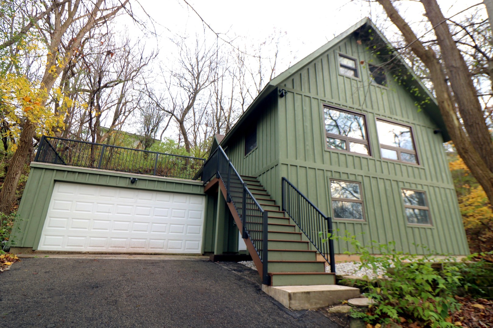 a view of a house with a small yard and wooden floor and fence