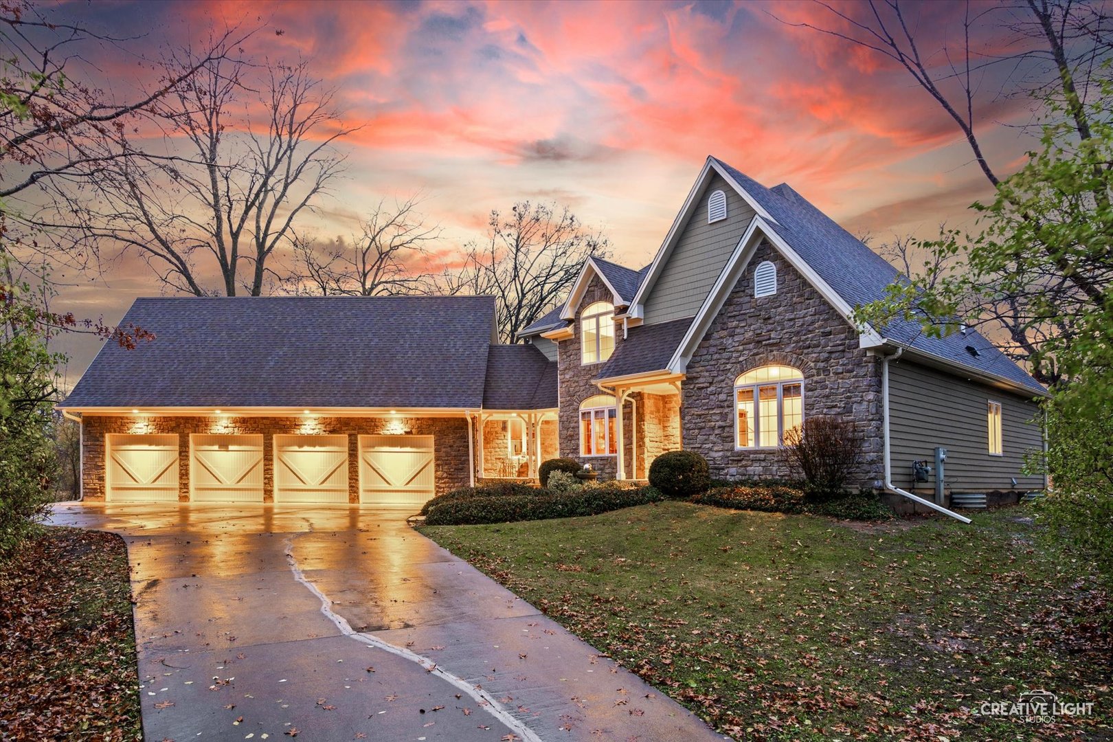 a front view of house with yard and trees around