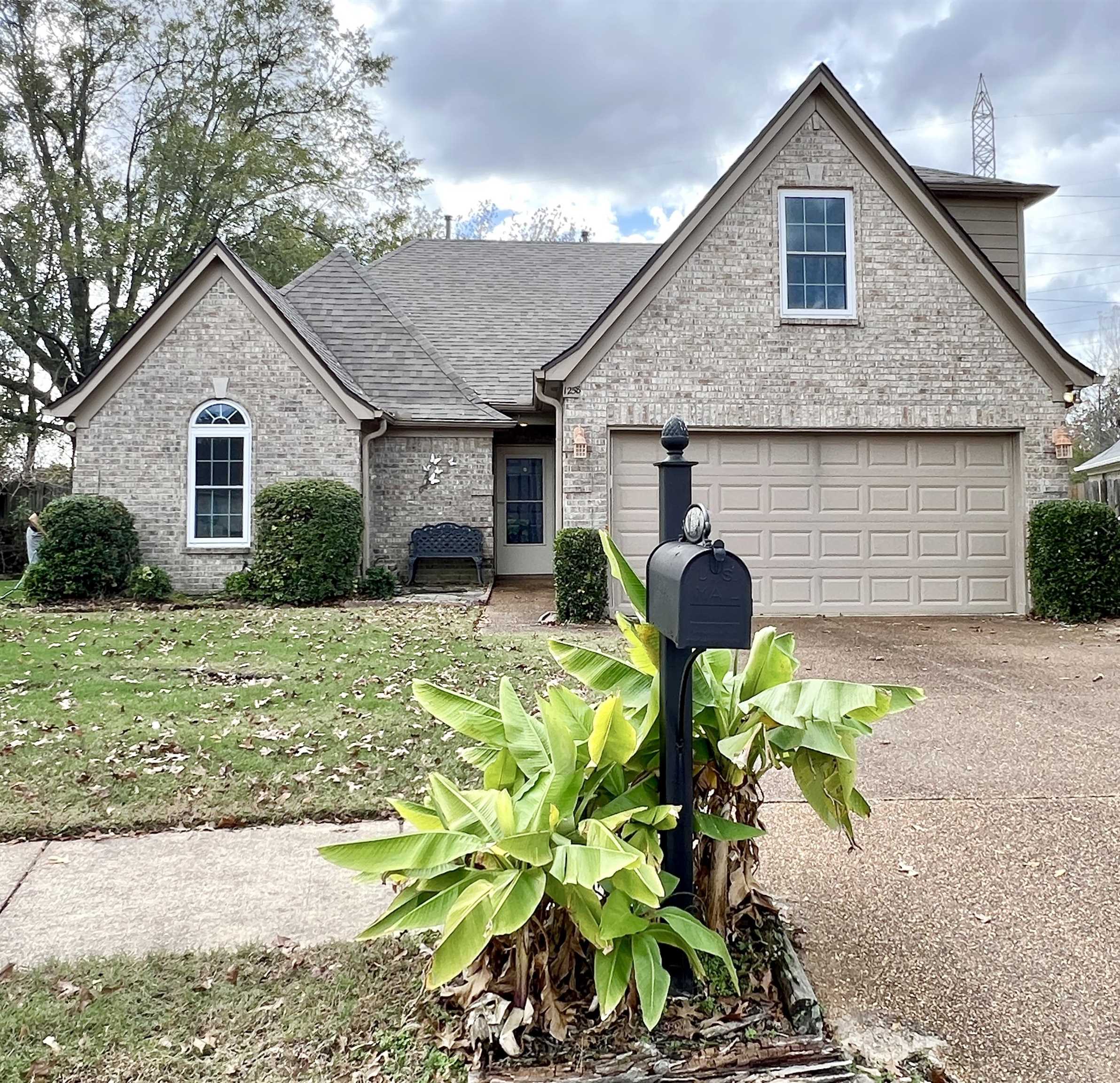 View of front of home with a front yard and garage