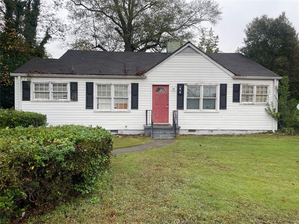 a front view of a house with a garden