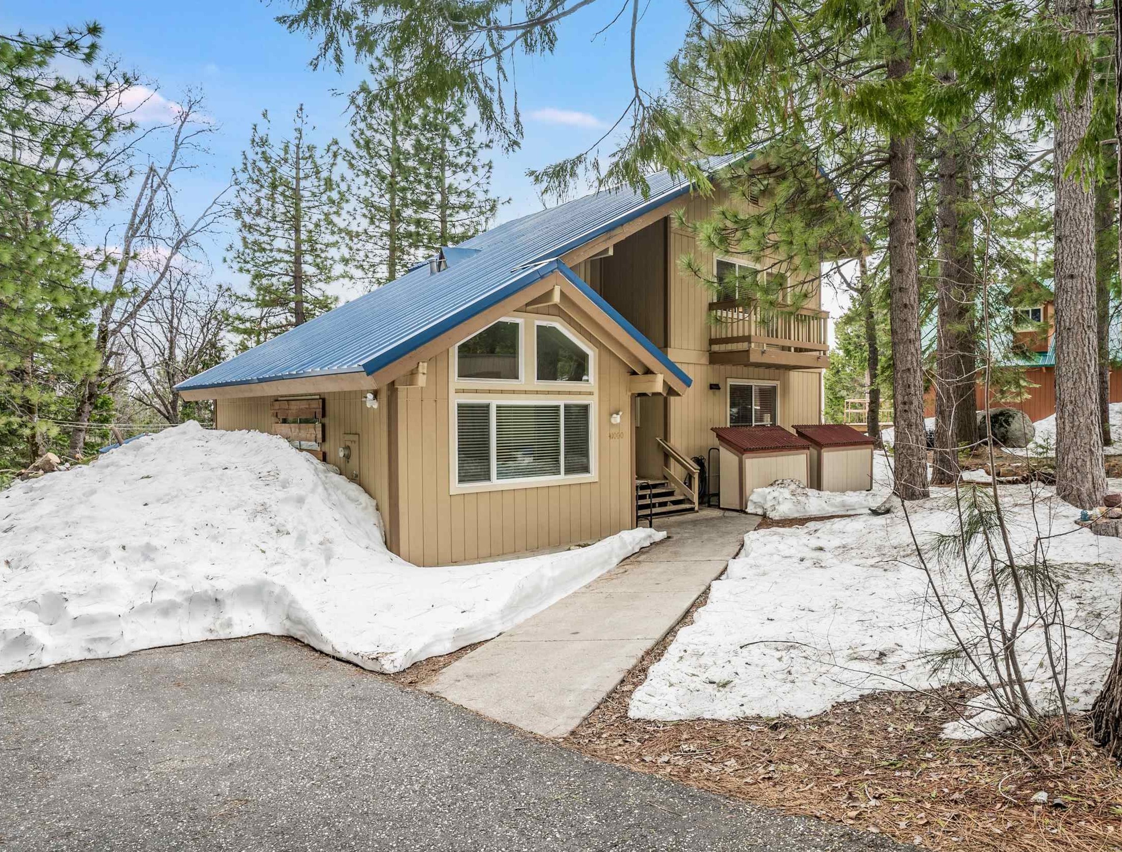 a view of a house with a yard covered in snow