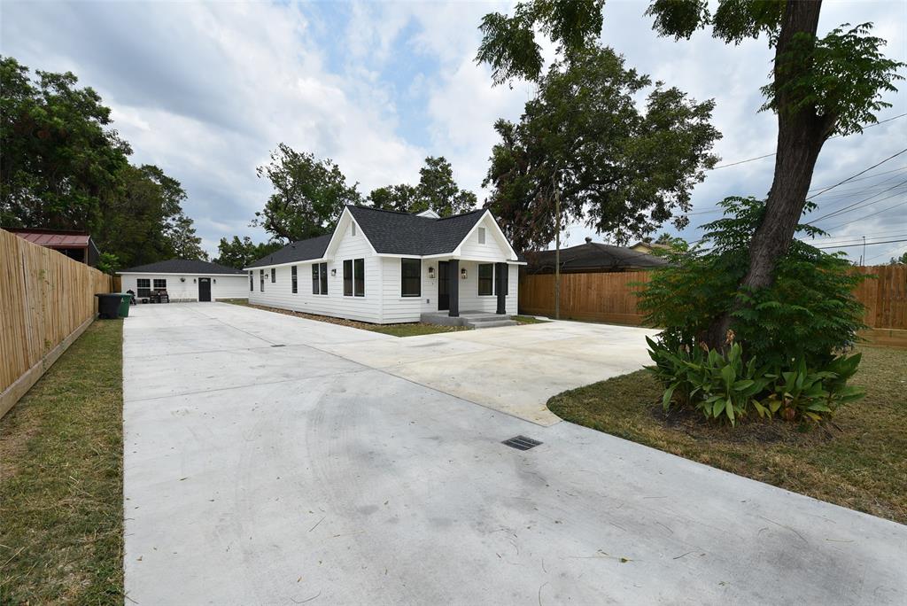 a view of a white house with a yard