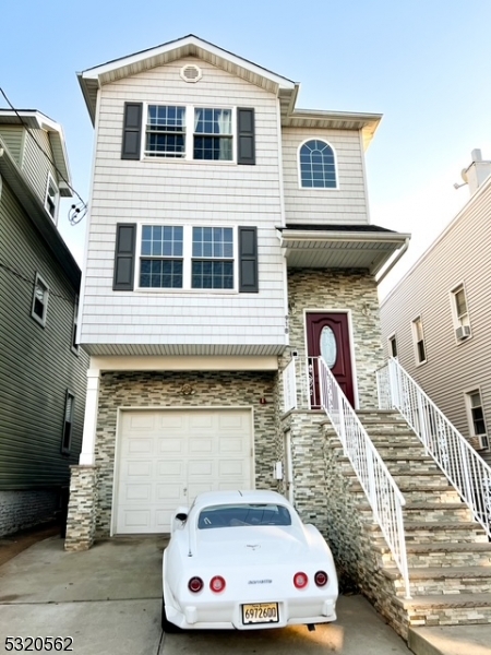 a front view of a house with stairs