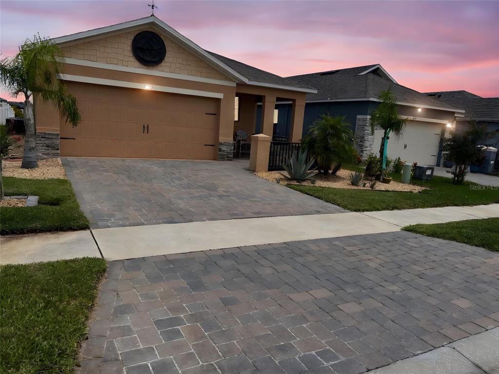 a front view of a house with a yard and garage