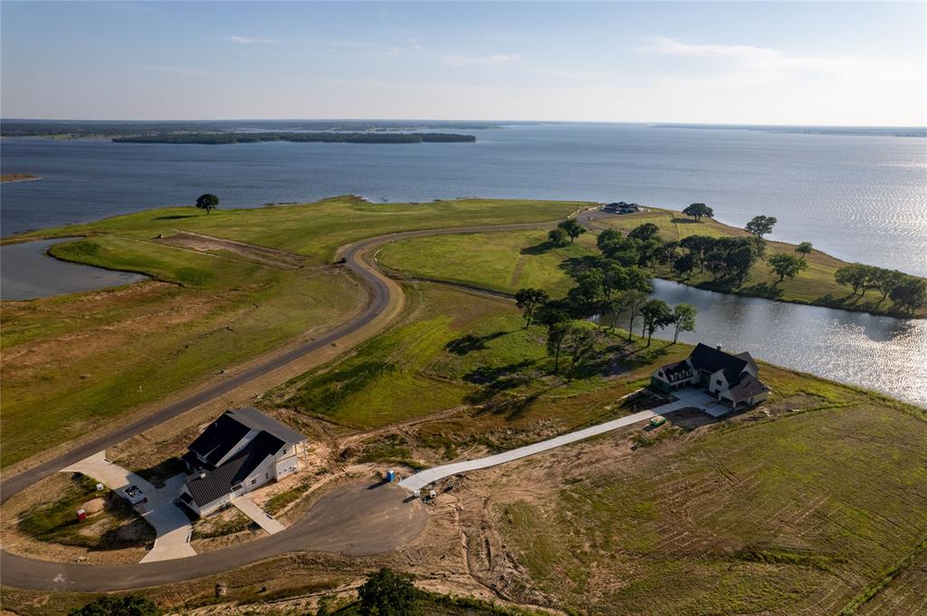 a view of a backyard of a house with a lake view