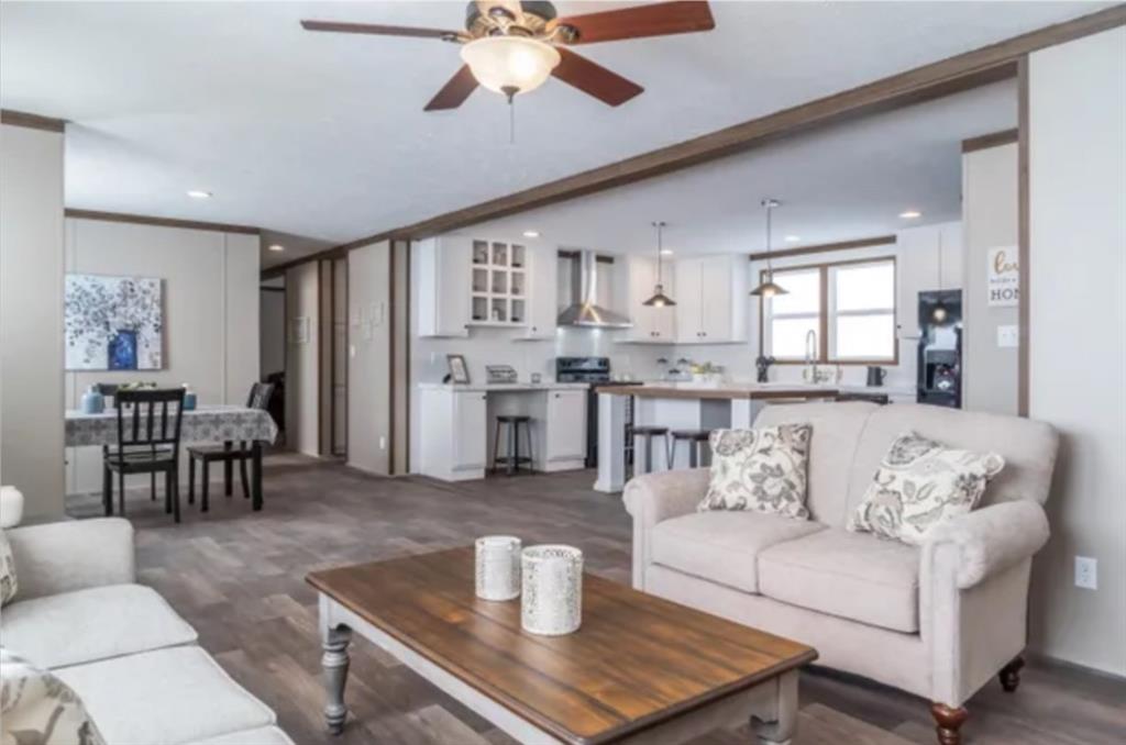 a living room with furniture and kitchen view