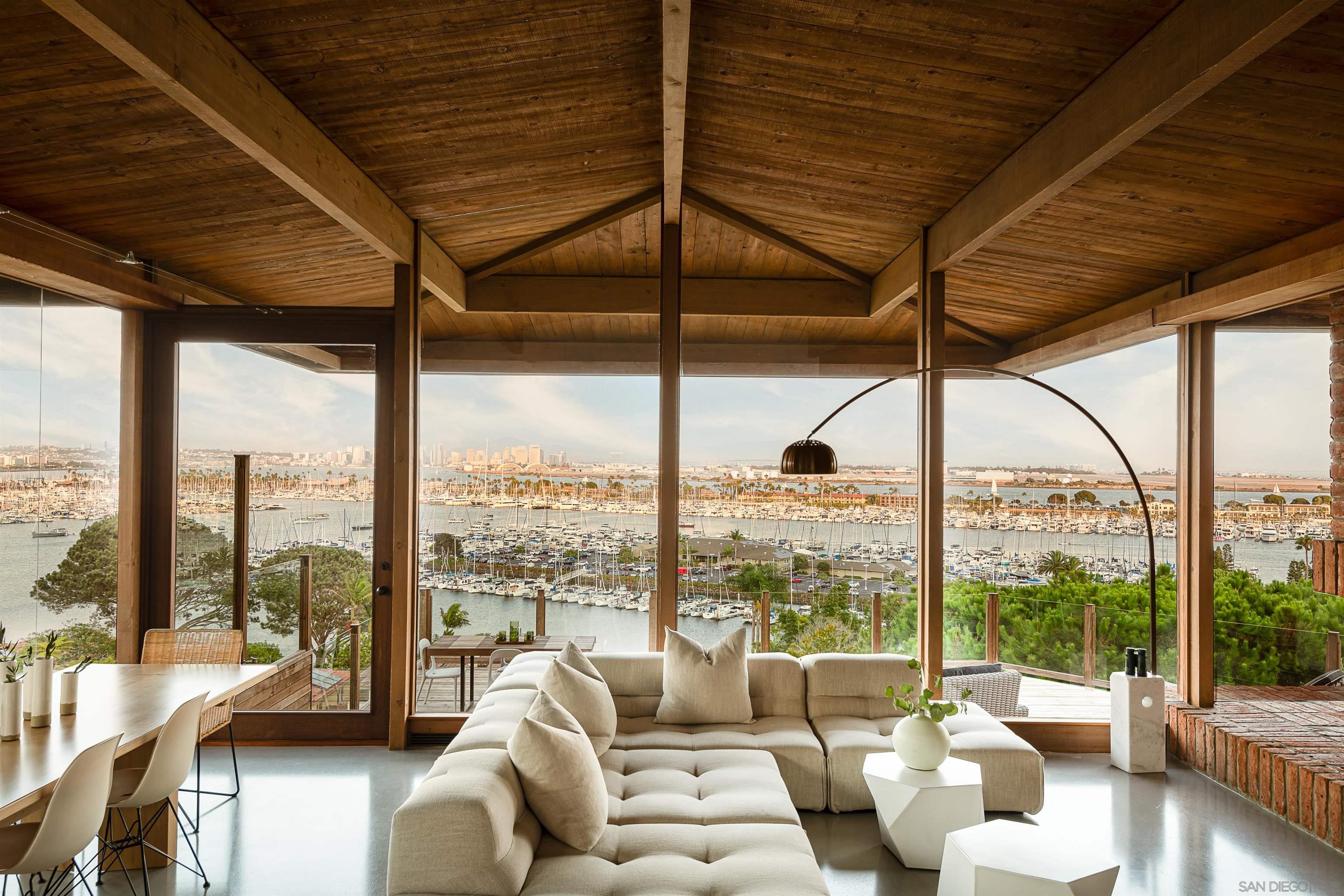 a living room with furniture and floor to ceiling windows