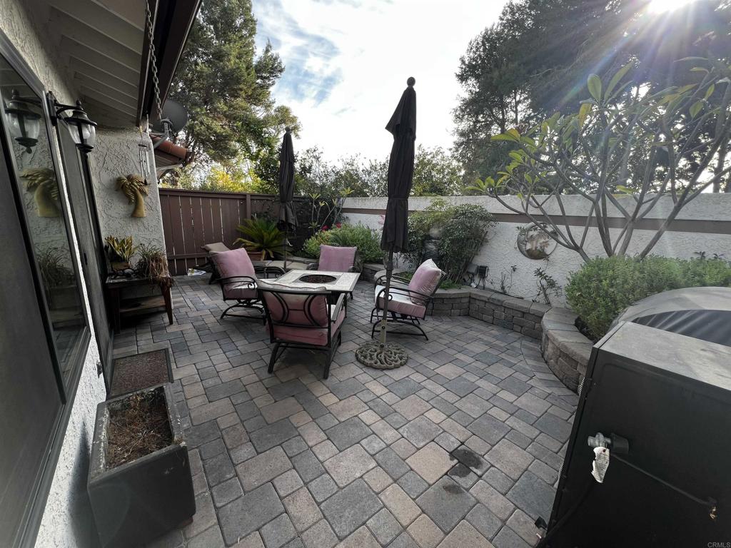 a view of a patio with table and chairs