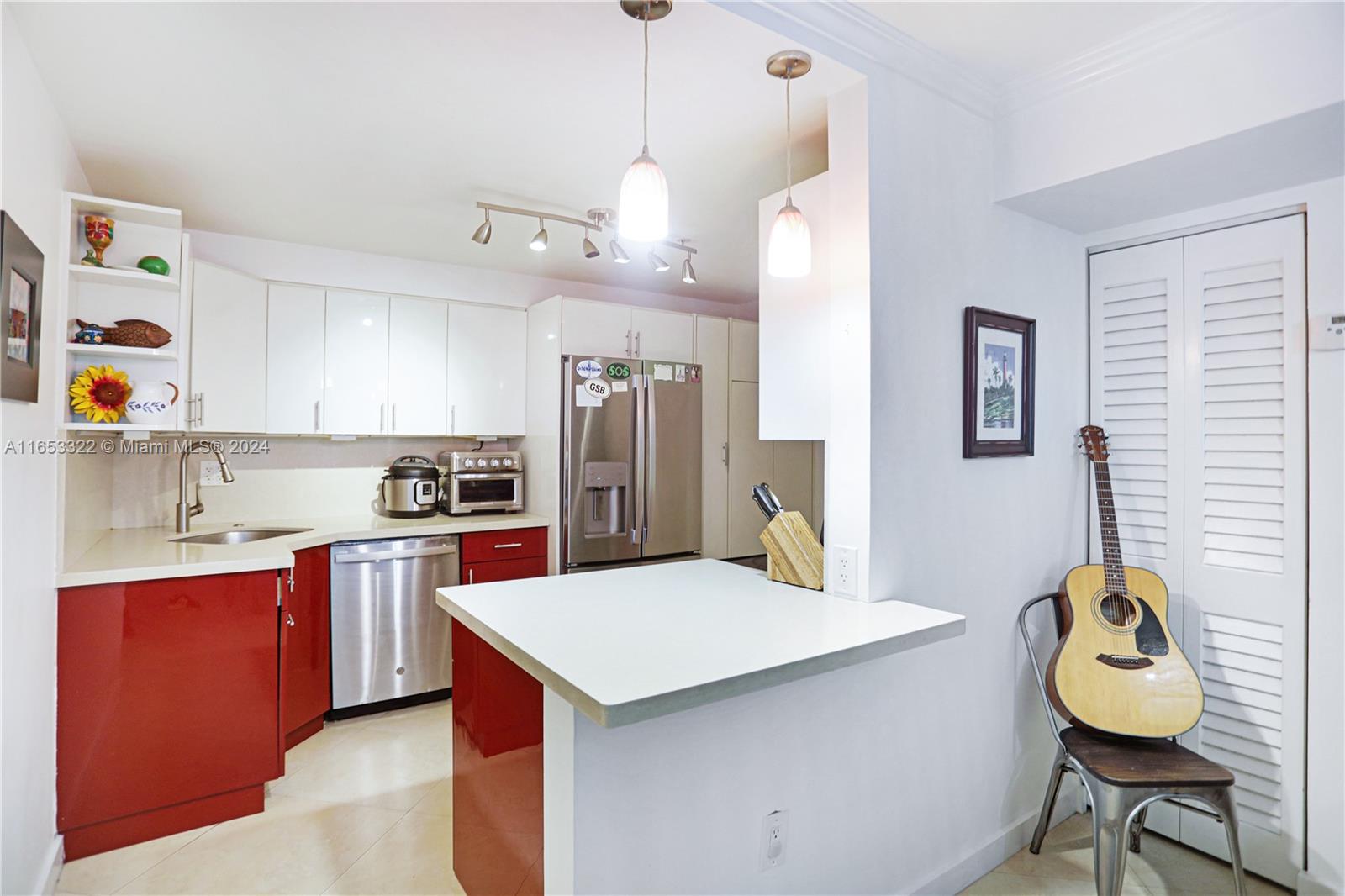 a kitchen with cabinets and wooden floor