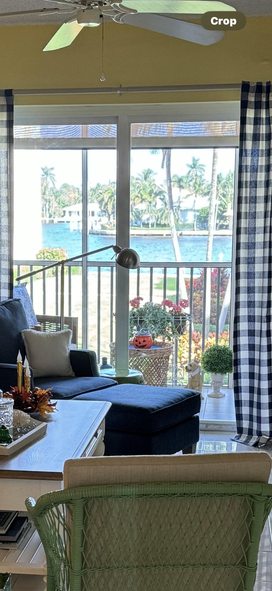 a living room with furniture and a floor to ceiling window