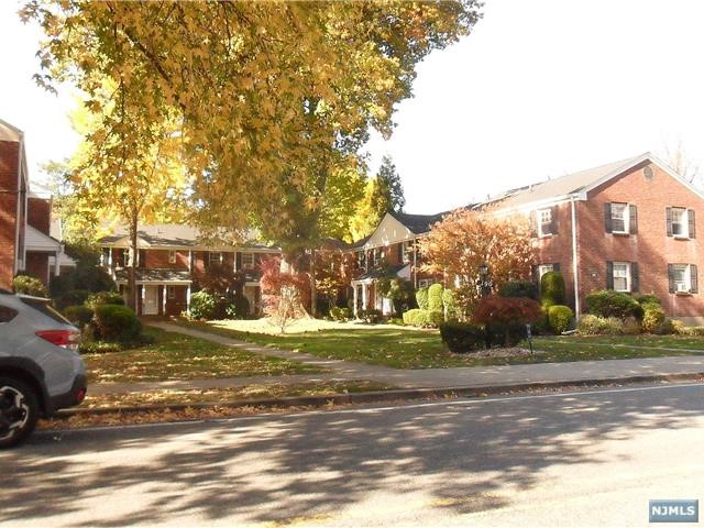 a view of a city street lined with buildings and trees