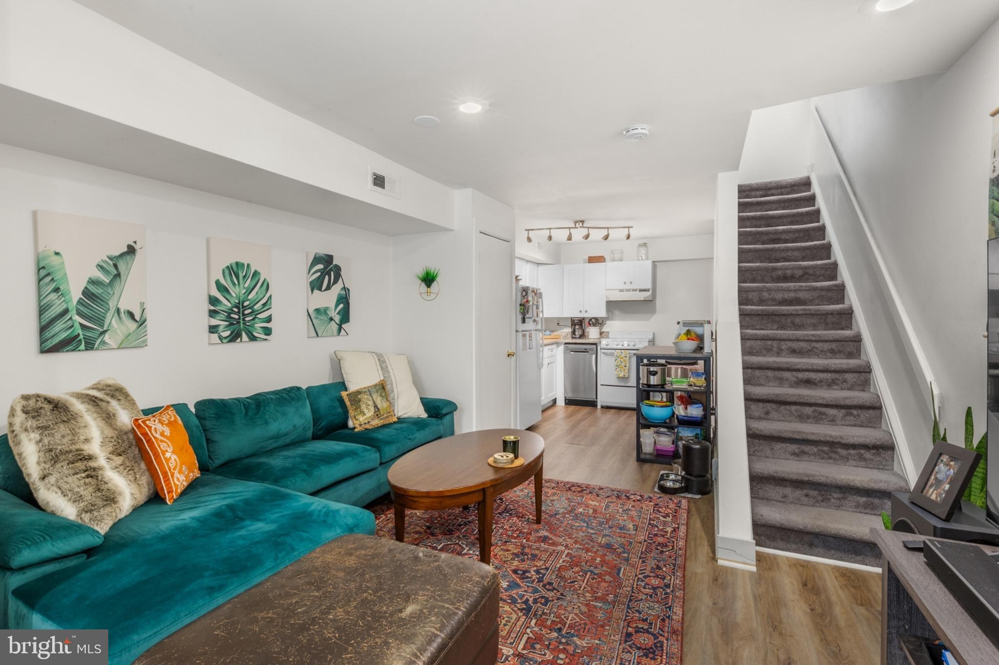 a living room with furniture and wooden floor