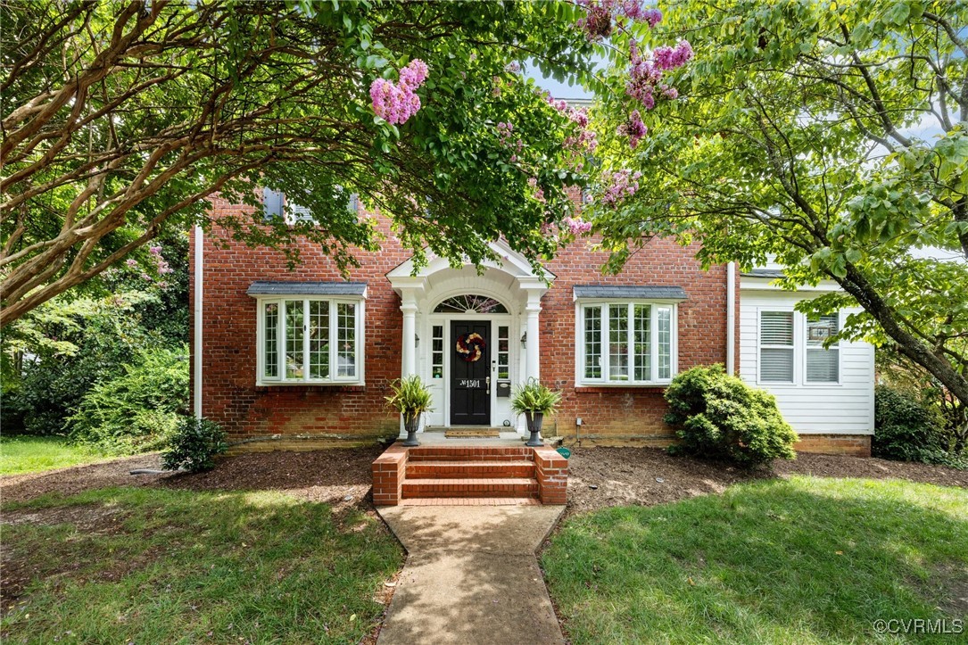 a front view of a house with garden