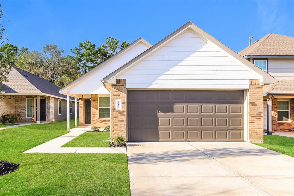 a front view of a house with a yard and garage