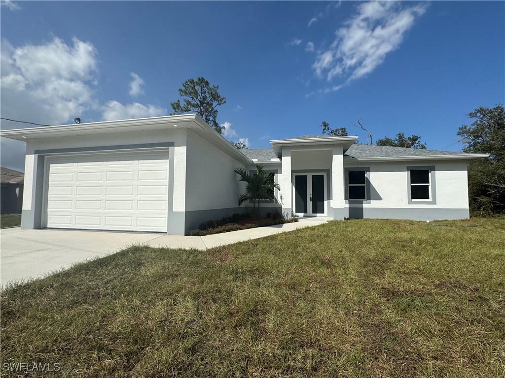 a front view of a house with a yard and garage