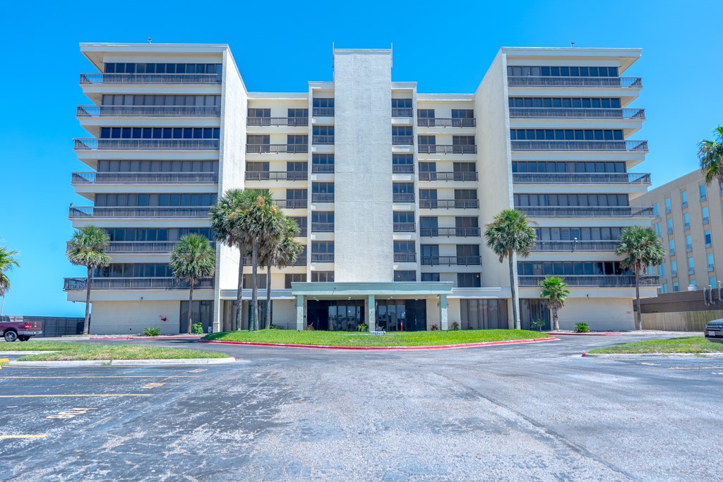 a front view of a building with a yard