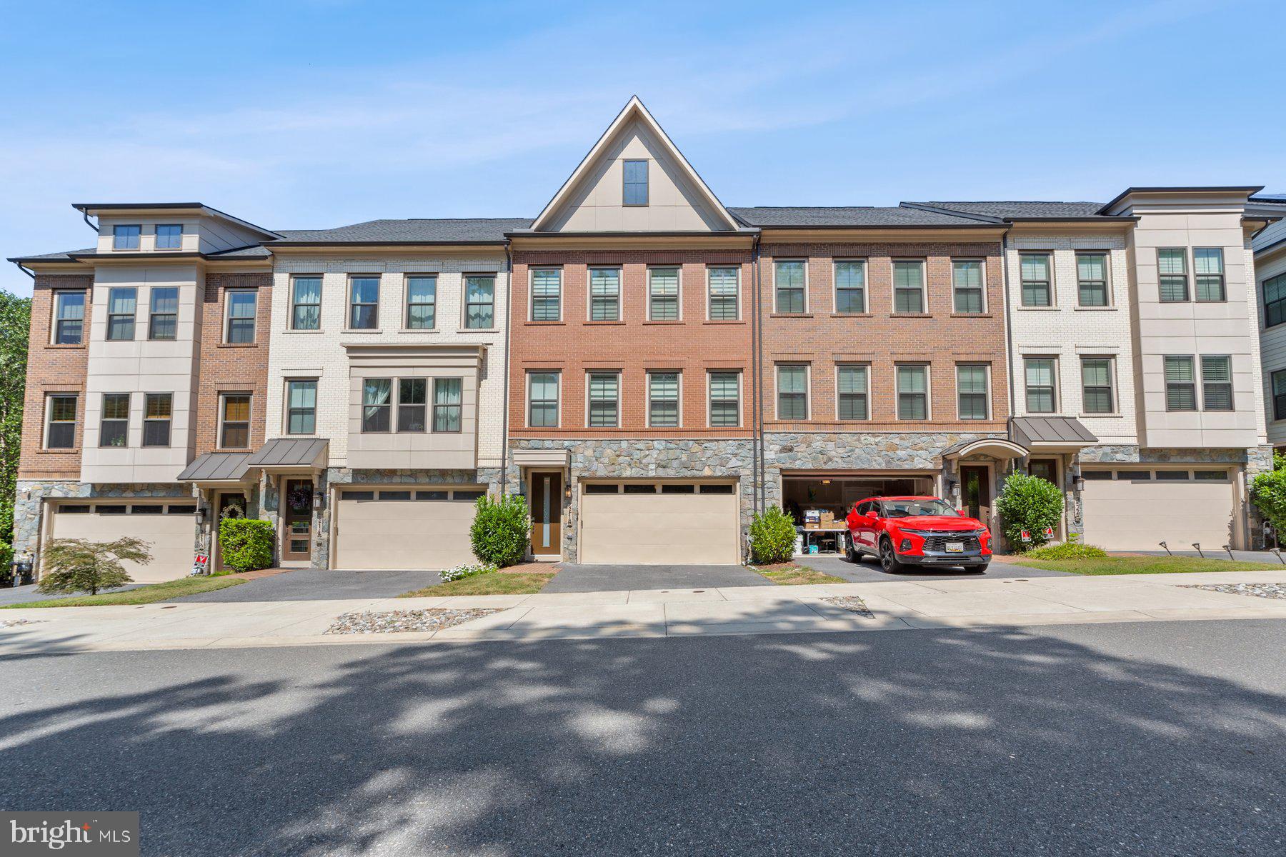 a front view of a residential apartment building with a yard