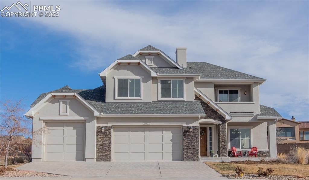 a front view of a house with garage