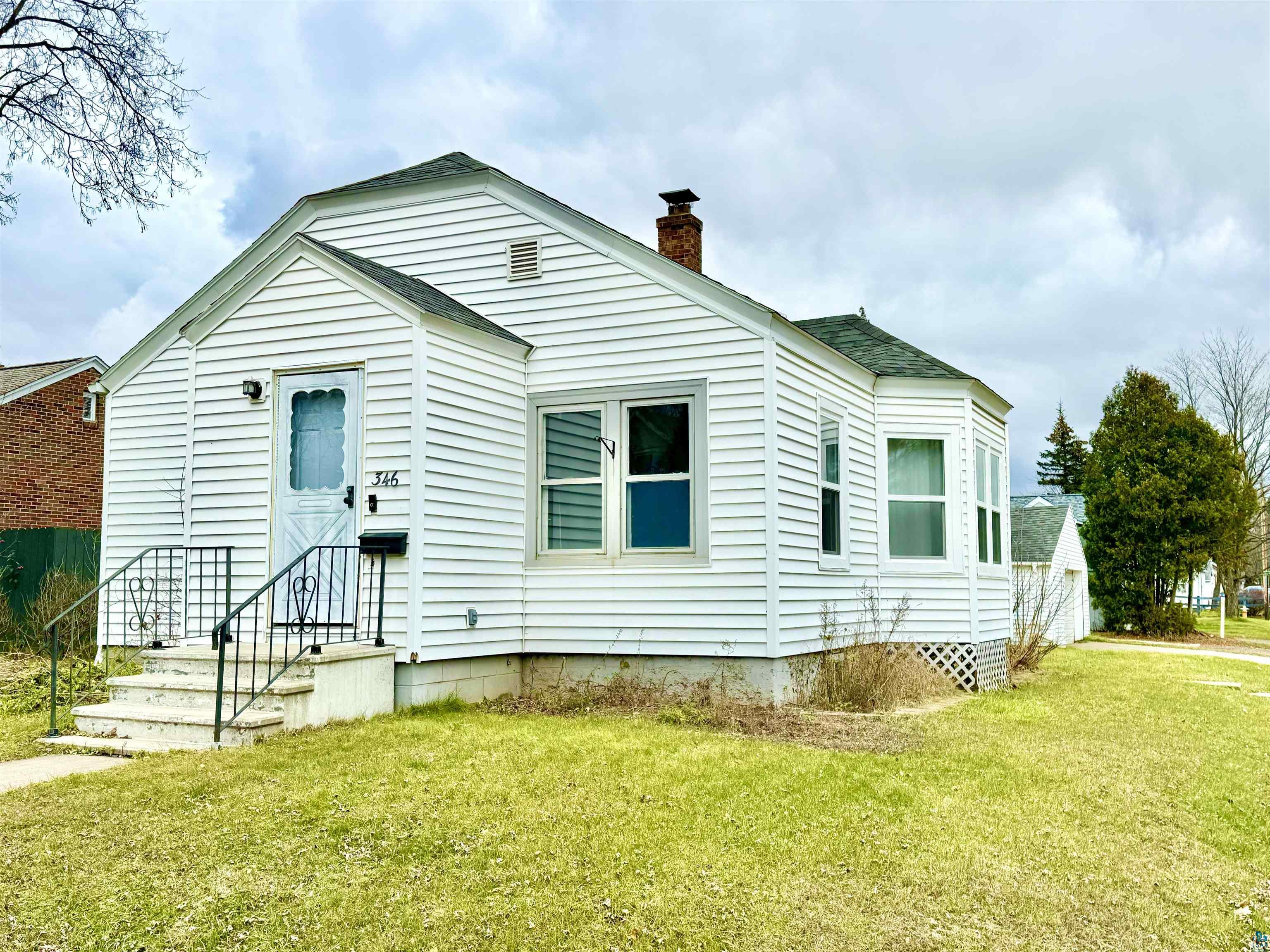 Back of house featuring a yard