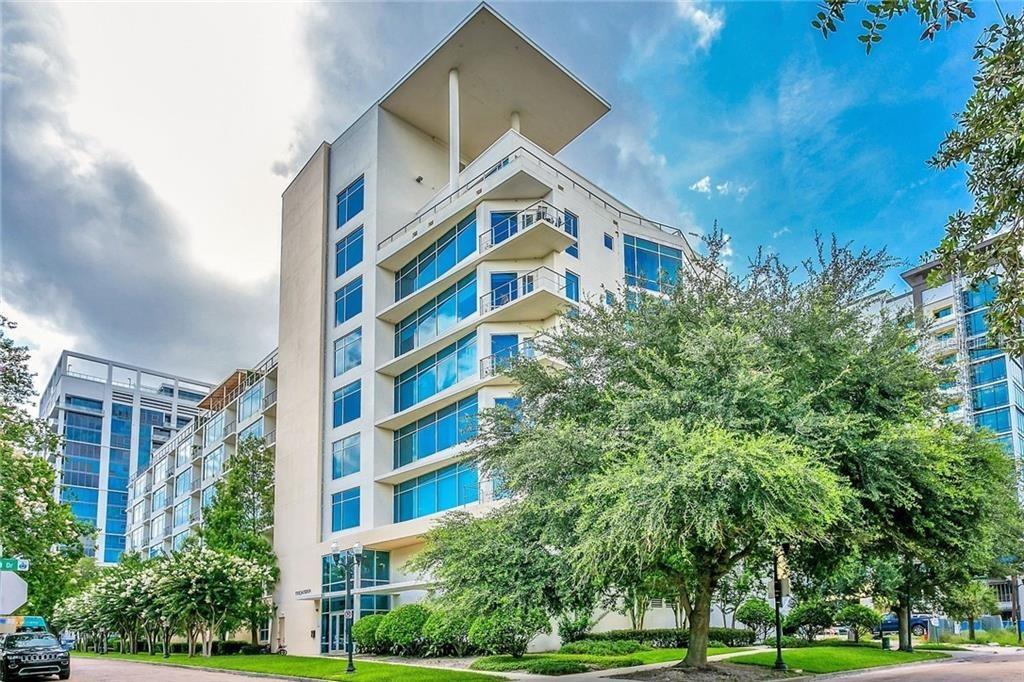 a view of a tall building next to a yard