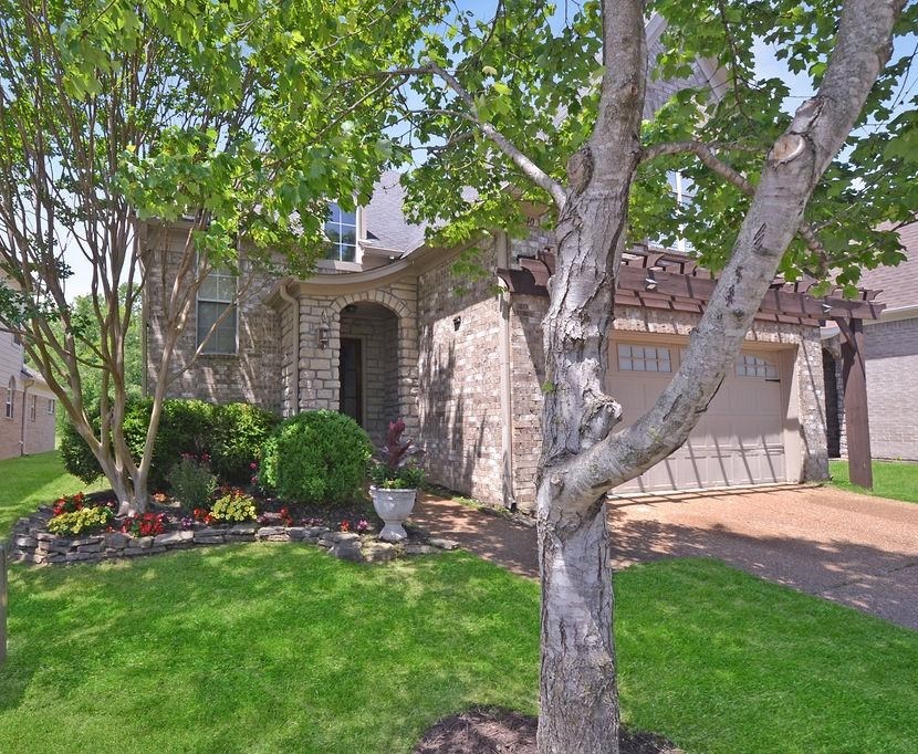 a front view of a house with garden