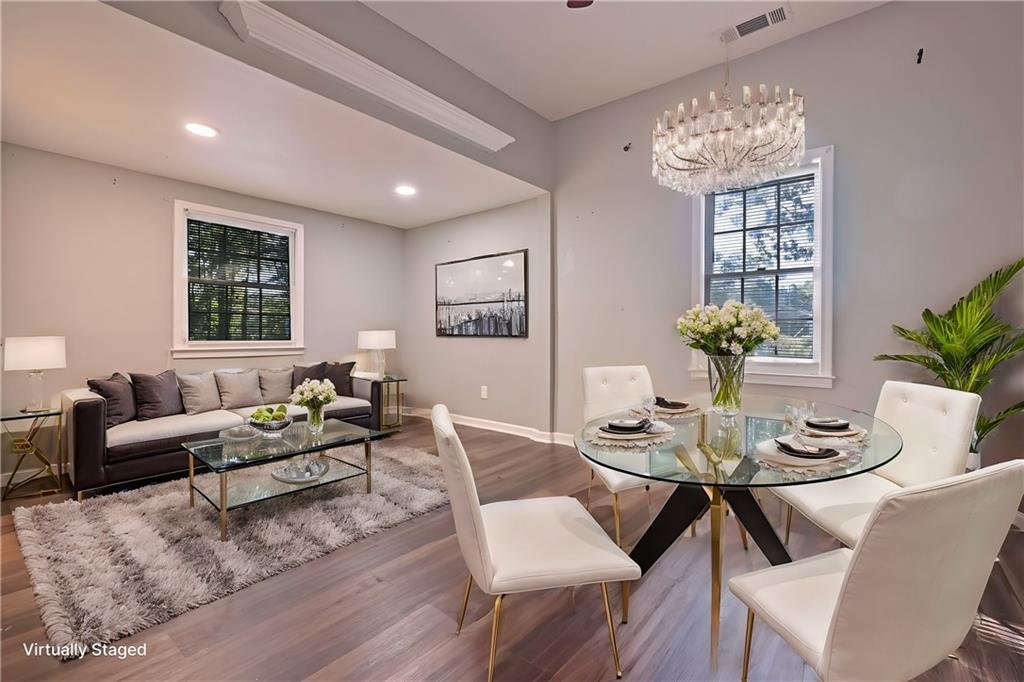 a living room with furniture flowers and a chandelier