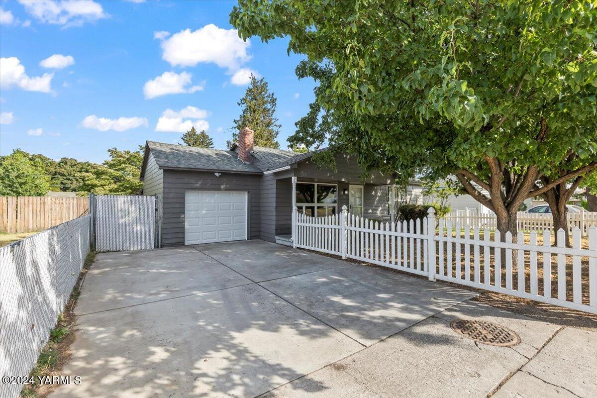 a view of a house with a wooden fence