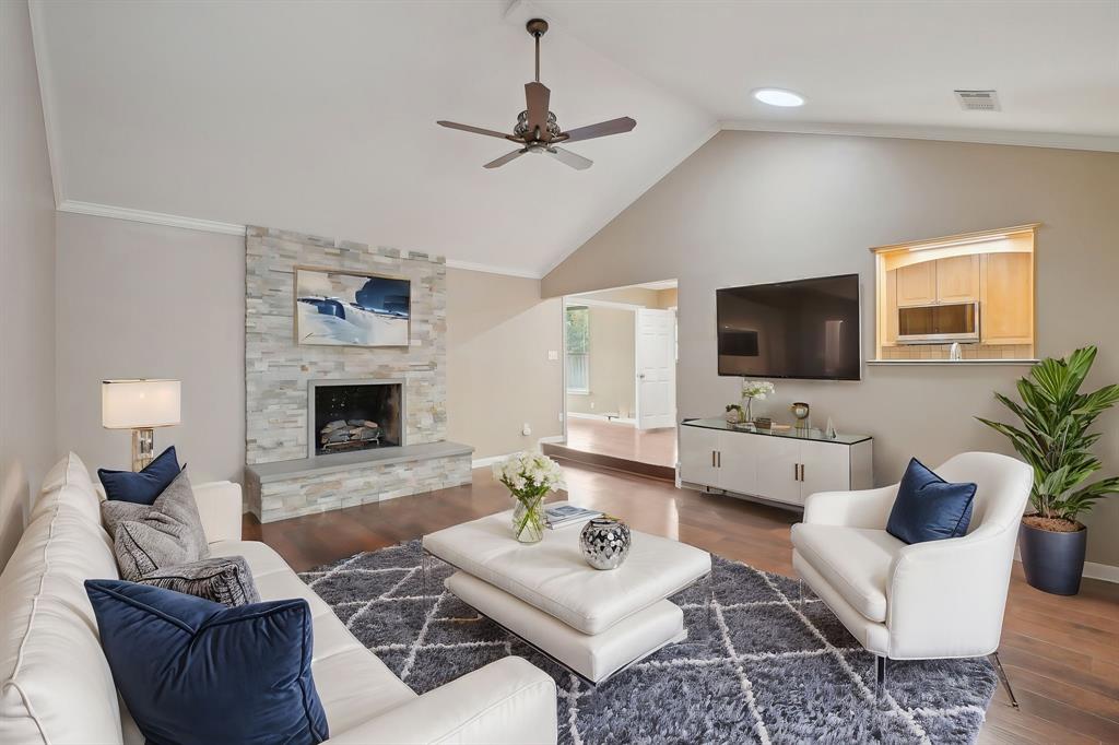 a living room with furniture a fireplace and a flat screen tv