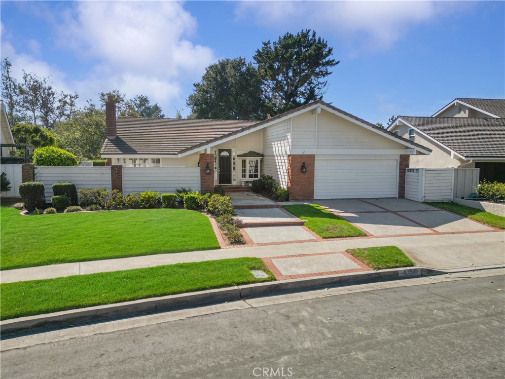 a house with green field in front of it