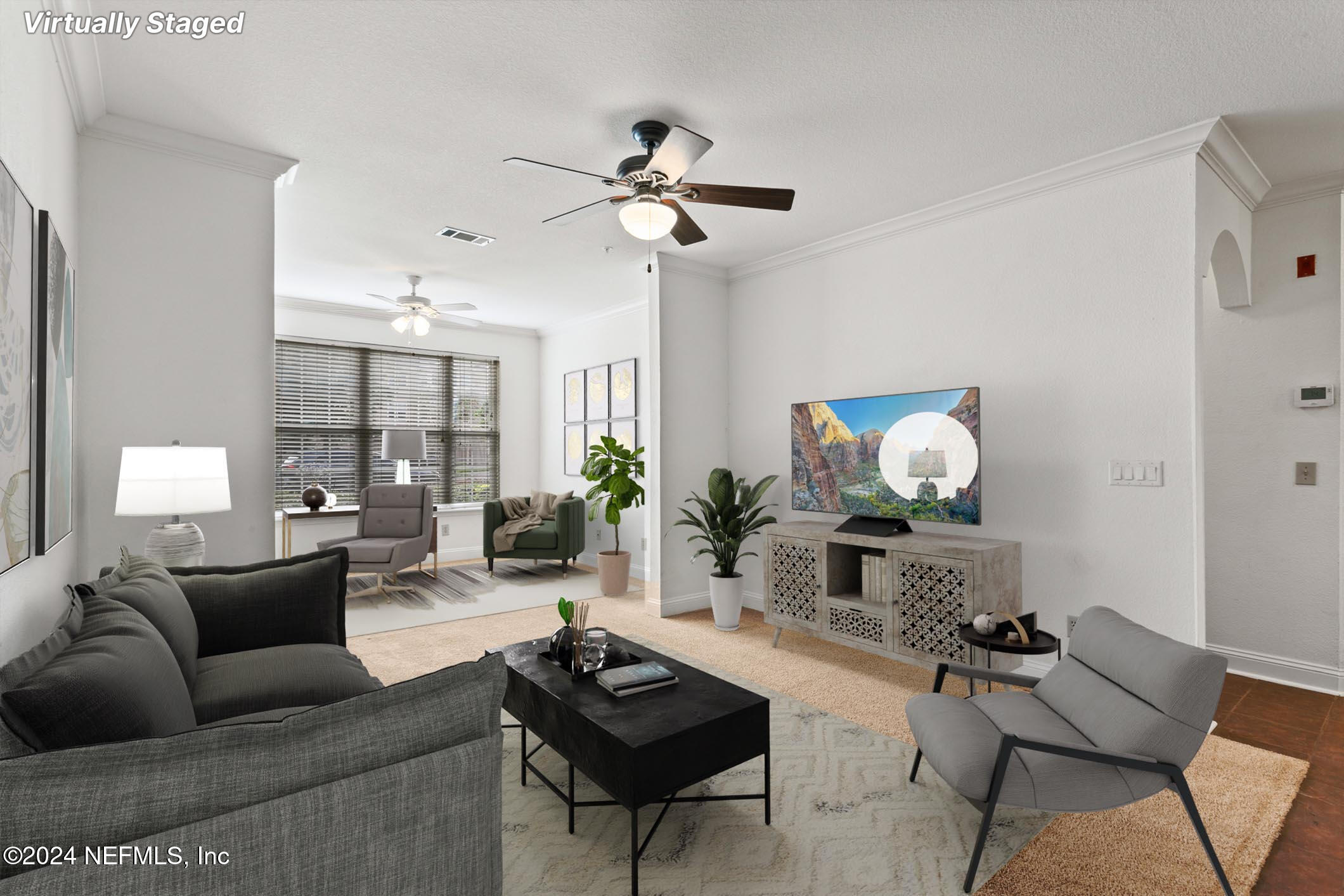 a living room with furniture and wooden floor