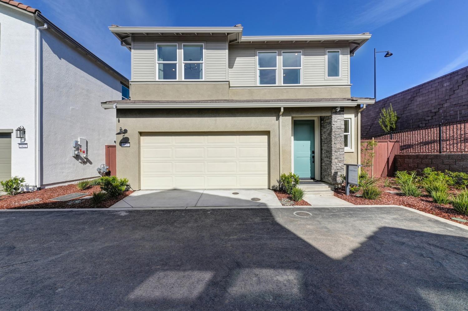 a view of a house with a yard and garage