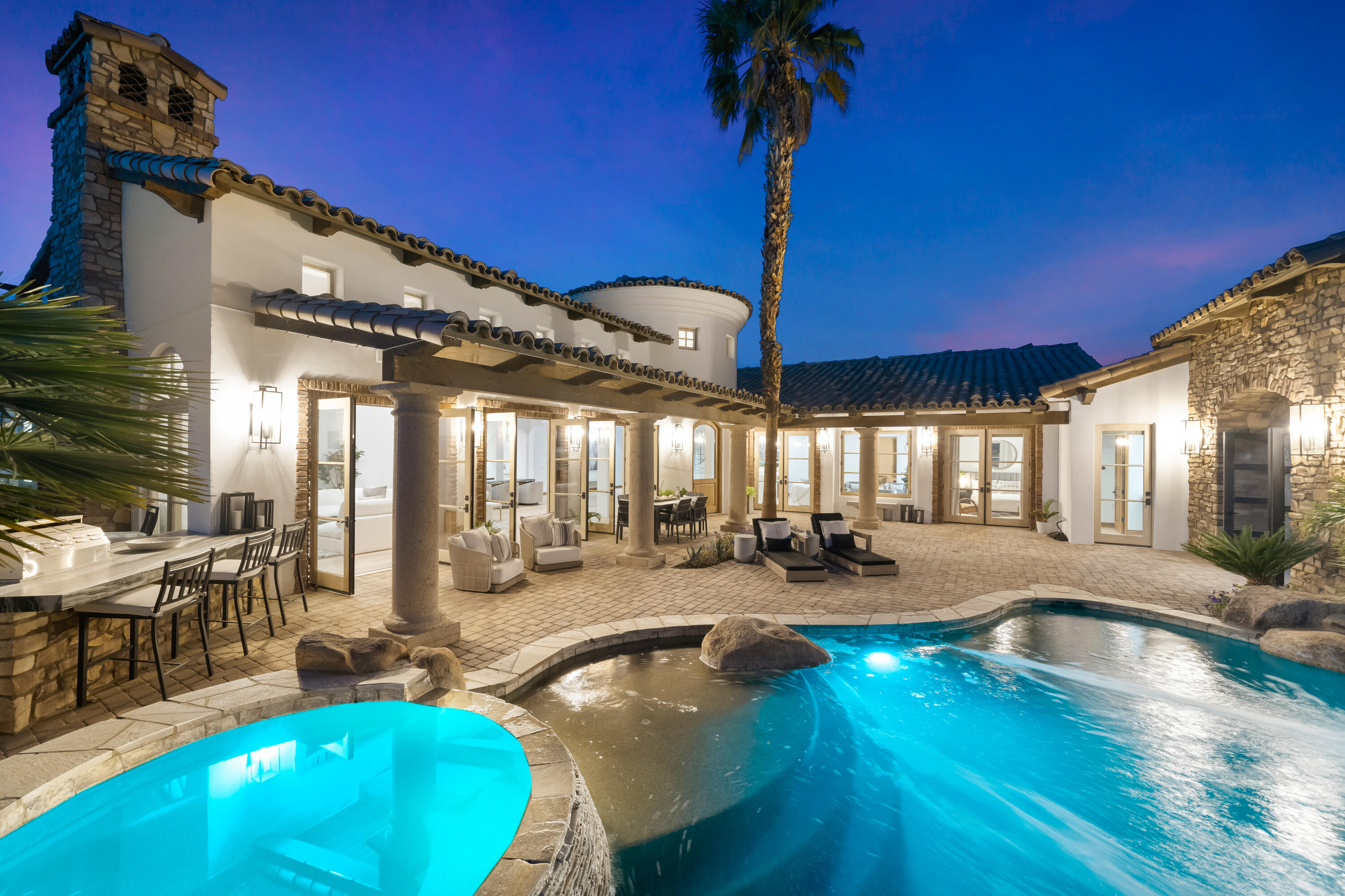 a view of a swimming pool with outdoor seating