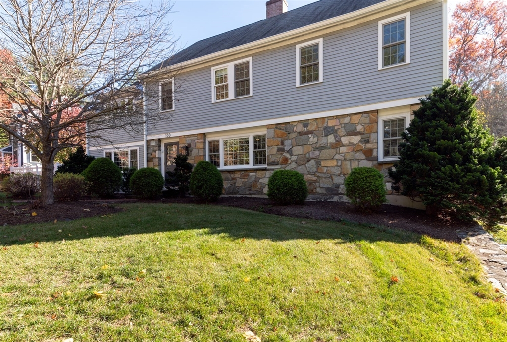 a view of house with backyard and garden