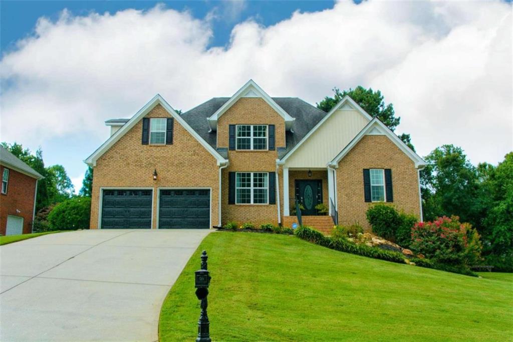 a front view of a house with garden