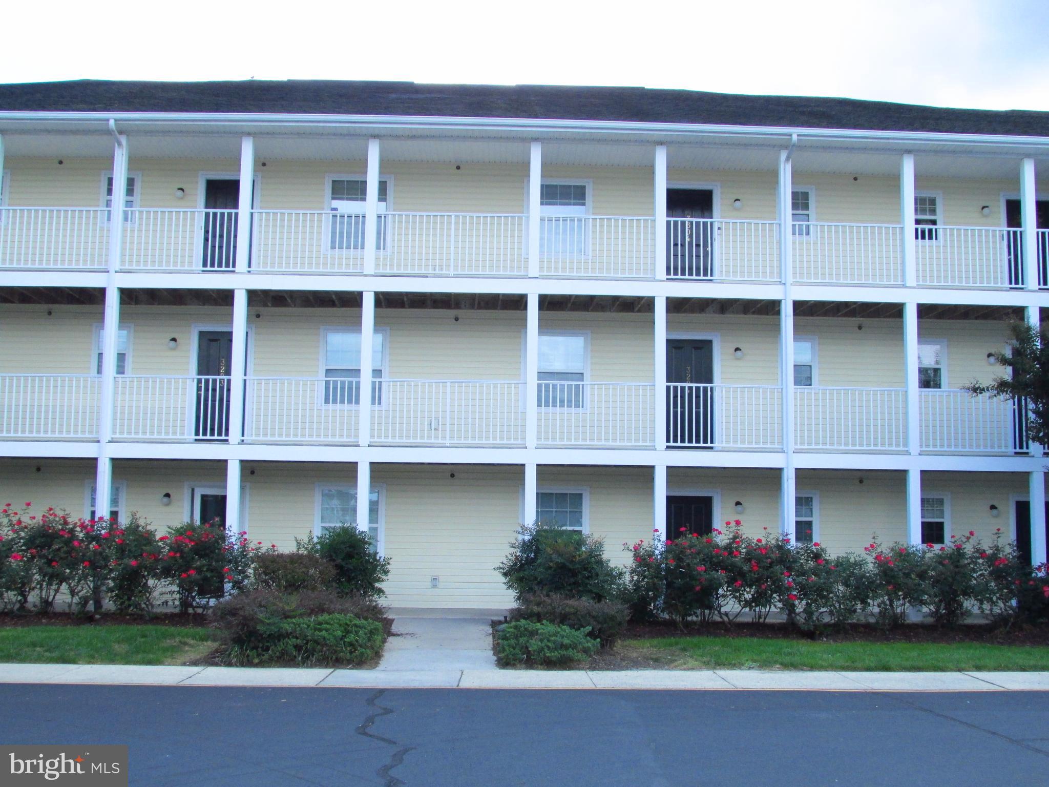 a front view of a building with garden