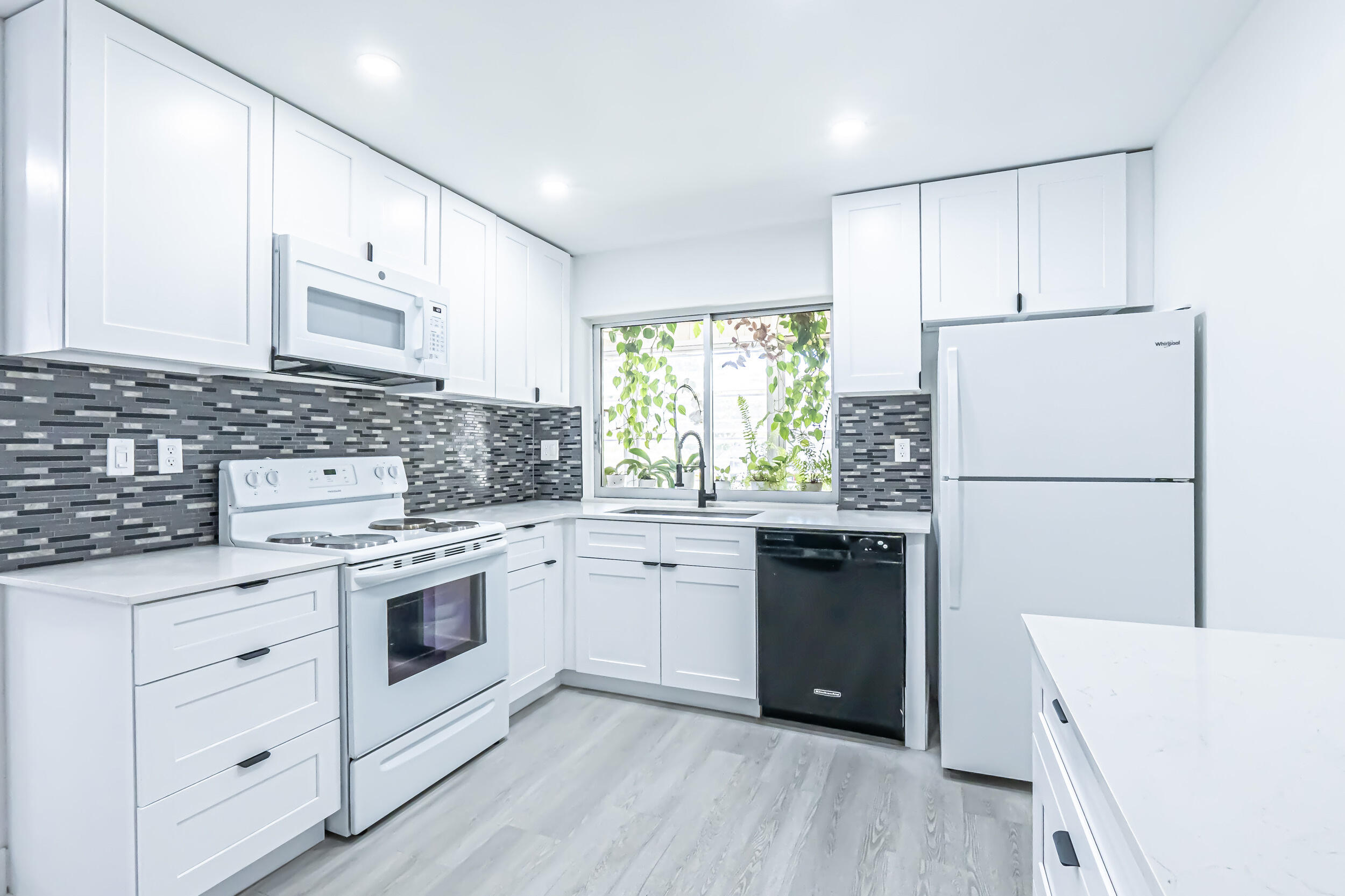 a kitchen with a white cabinets and white appliances