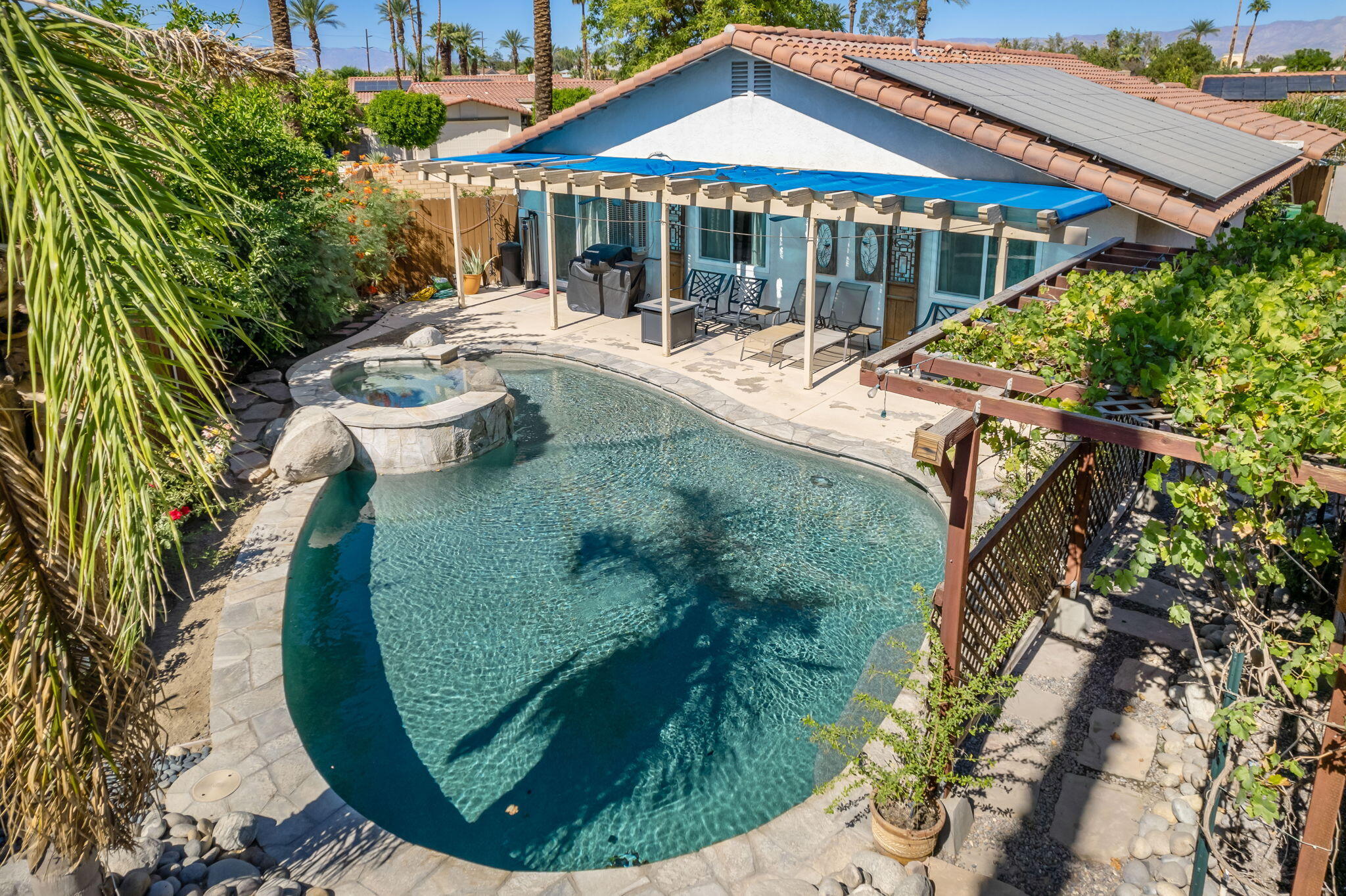 a view of a house with swimming pool and porch