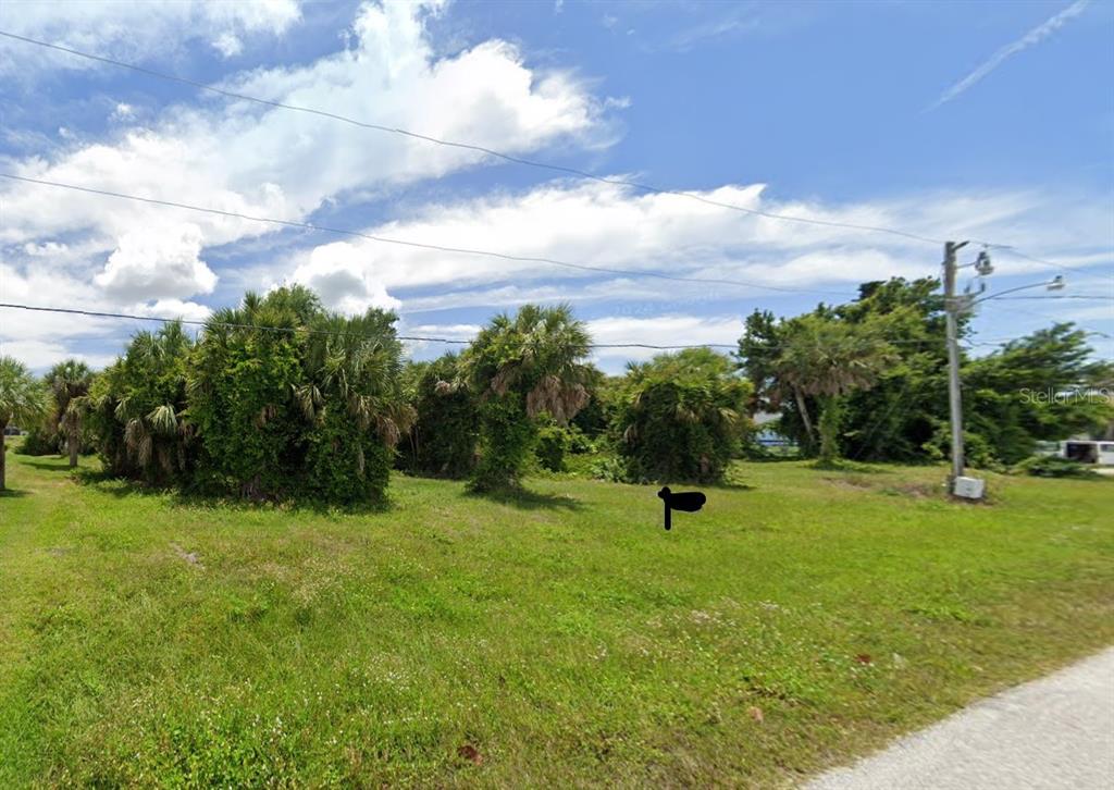 a view of a garden with a house in the background