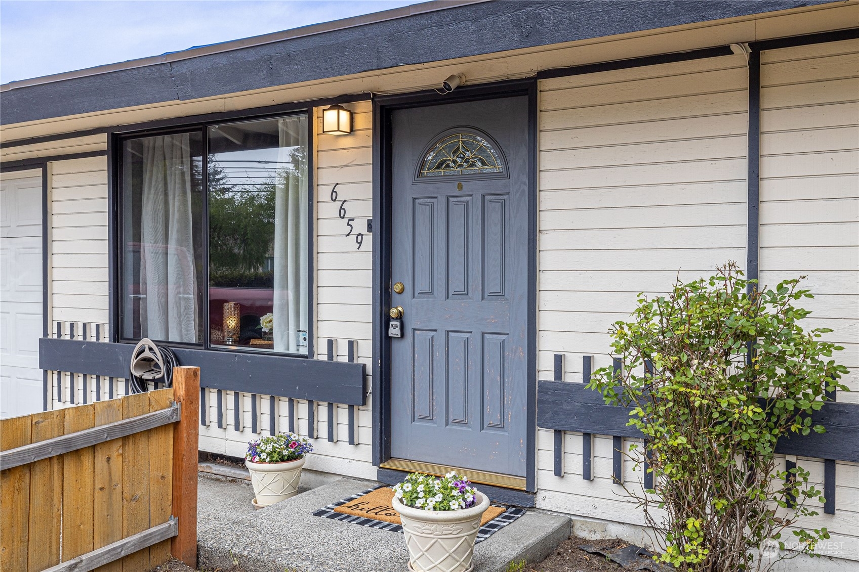 a front view of a house with outdoor seating