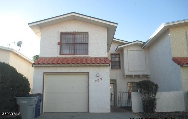 a front view of a house with garage