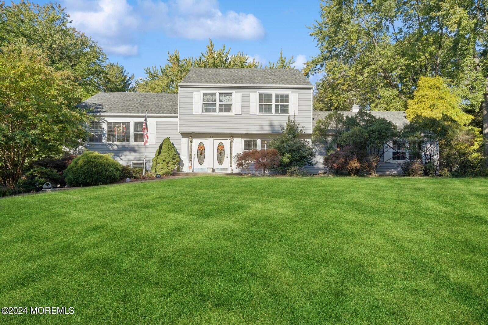 a front view of house with yard and green space