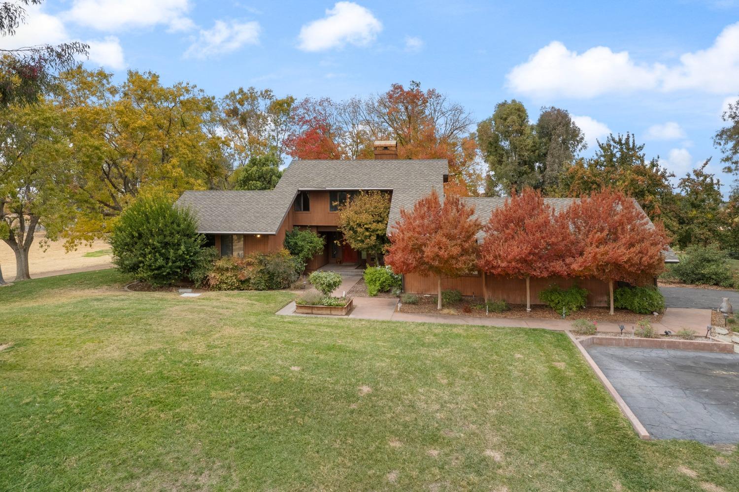 a view of a house with a yard and sitting area